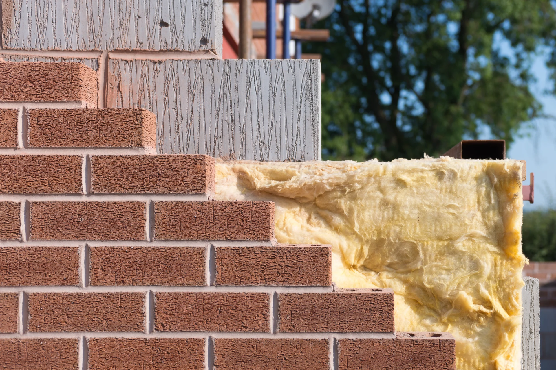 Construction site showing cavity wall insulation layers.