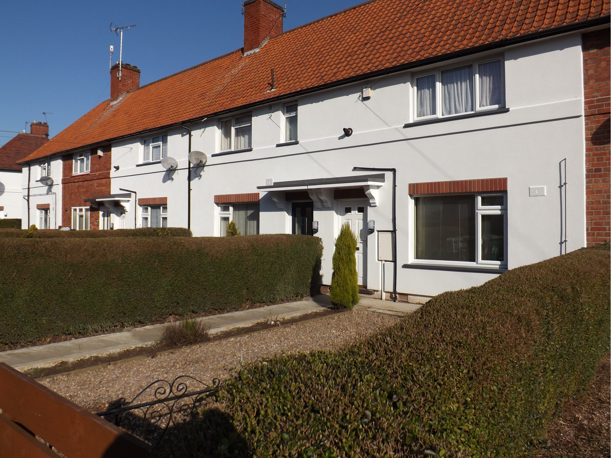 Row of houses with House with white external wall insulation